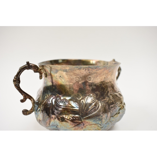 8069 - A Charles II provincial silver two handled porringer with embossed floral detail, 8.5cm tall, 9.7cm ... 