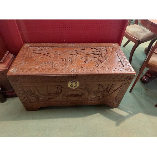 4041 - A mid-20th Century Chinese camphor wood chest with carved figural detailing, 52cm tall x 100cm wide ... 