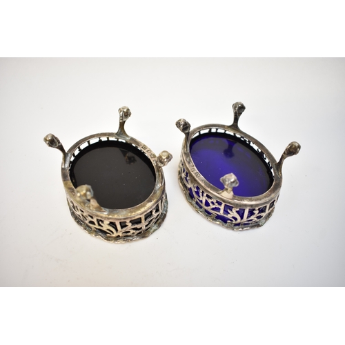 8089 - A pair of David Hennell I and Robert Hennell I pierced silver silver salts raised on four ball and c... 