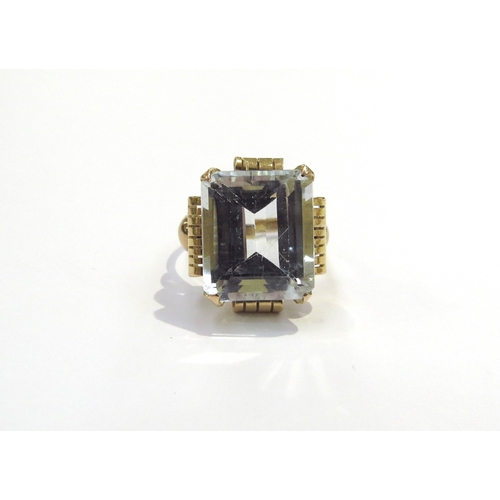 6037 - An unmarked gold ring set with a large pale blue stone. Size L, 5.2g