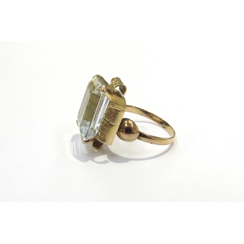 6037 - An unmarked gold ring set with a large pale blue stone. Size L, 5.2g