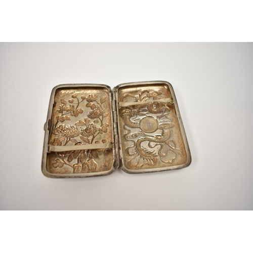 8073 - A Chinese silver cigarette case by Yung Lei Shanghai 1880-1915 with images of chrysanthemums and dra... 