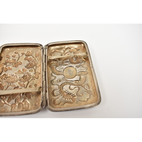 8073 - A Chinese silver cigarette case by Yung Lei Shanghai 1880-1915 with images of chrysanthemums and dra... 