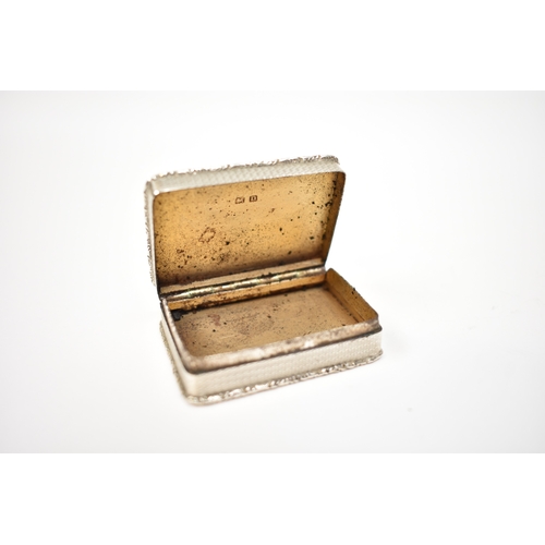 8035 - An early 20th Century silver snuff box, engine-turned detail and foliate relief border, 48mm x 37mm,... 