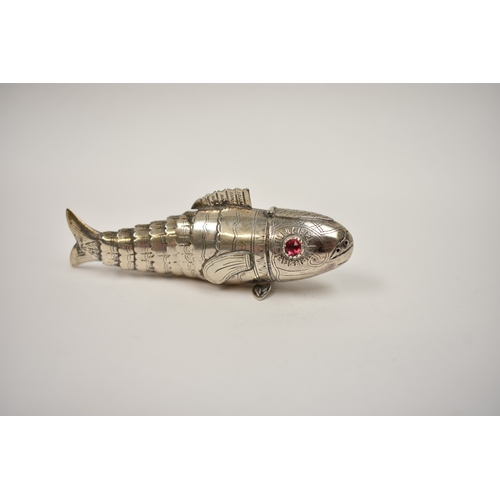 8026 - A silver articulated fish spice box, ruby coloured eyes, stamped 830S, with hinged perforated head, ... 