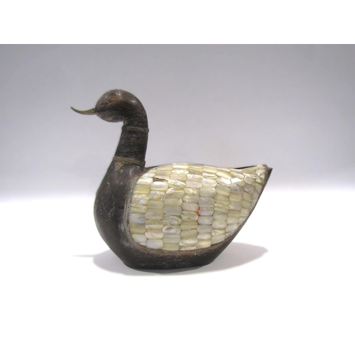 1001 - A carved hardwood duck with brass beak and banded details of mother-of-pearl wings, 28cm length x 24... 