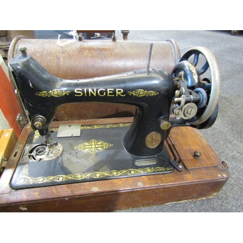 1048 - A Singer sewing machine, oak cased, and a Vanguard De Luxe sewing machine, cased