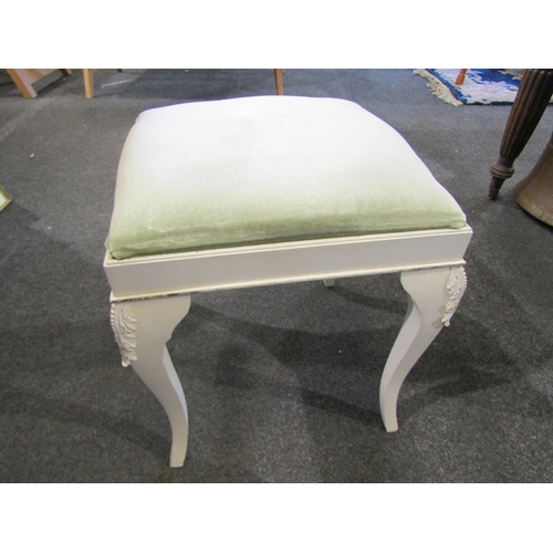 1055 - A white painted dressing table stool on cabriole legs