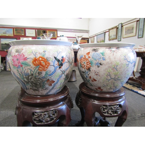 1094 - A pair of 20th Century Chinese ceramic goldfish bowls, 40cm diameter, with associated hardwood stand... 