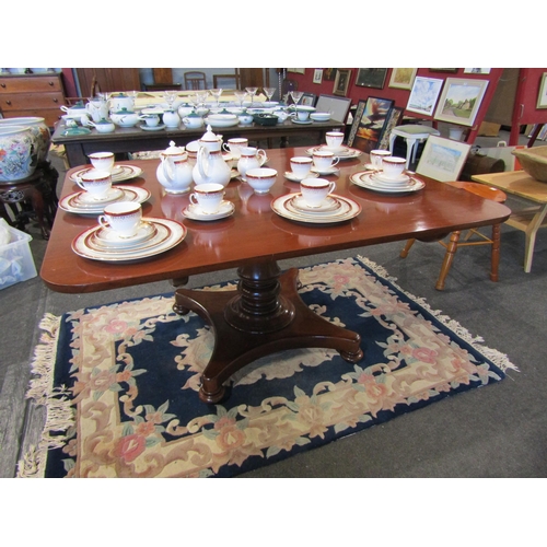 1104 - A circa 1840 flame mahogany round cornered tilt top table over turned bulbous column and plateau bas... 