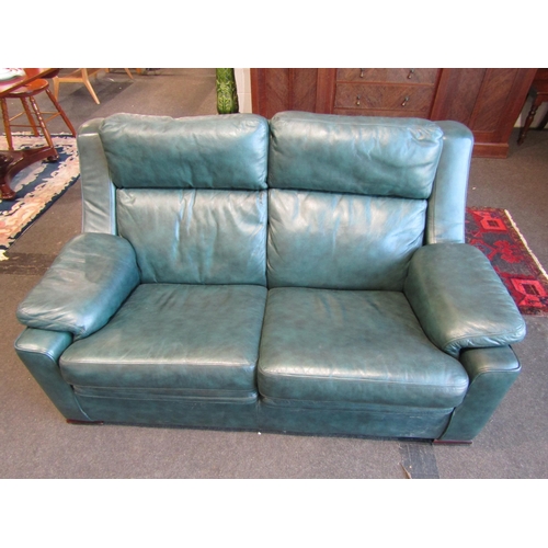 1108 - An emerald green leather two seater sofa and matching armchair