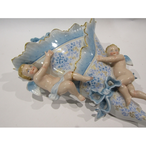 1206 - A Continental ceramic wall pocket decorated with winged putti, top bow a/f (missing piece) and leg r... 