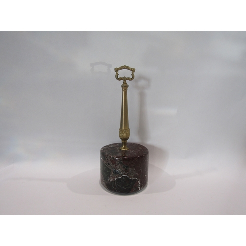 1214 - A marble and brass topped door stop, 29.5cm tall