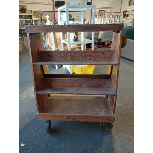 1082 - A pine mid-century Red Cross Hospital book trolley with Art Deco shaped handles on either side, 108c... 