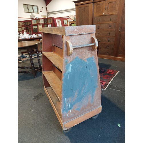 1082 - A pine mid-century Red Cross Hospital book trolley with Art Deco shaped handles on either side, 108c... 