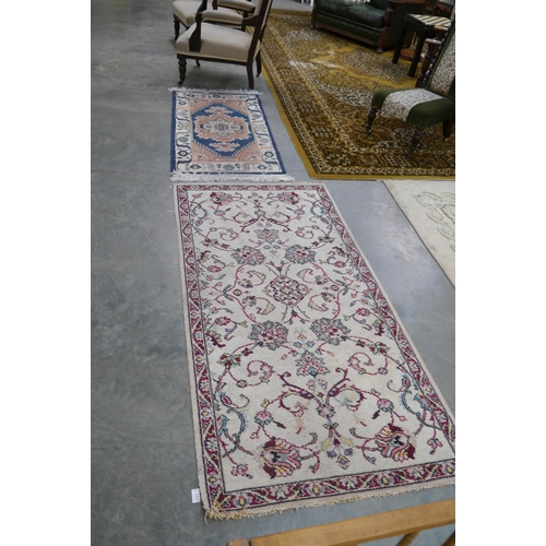 2337 - Two cream ground rugs, 90x180cm and 70x140cm