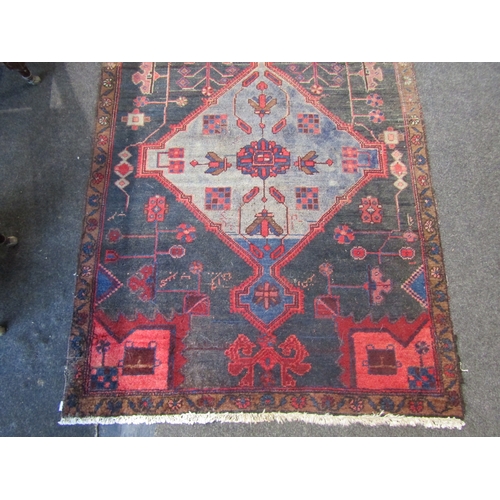 1019 - An Iran (Persian) rug, red and blue ground with geometric design, tasselled ends, slightly worn, 215... 