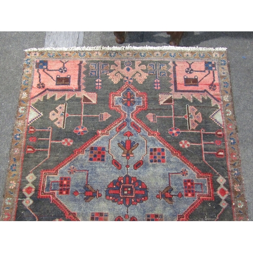 1019 - An Iran (Persian) rug, red and blue ground with geometric design, tasselled ends, slightly worn, 215... 