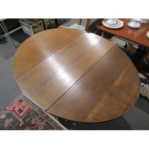 1086 - An 18th Century and later oak gateleg table the rising leaf oval top on cotton reel turned legs and ... 