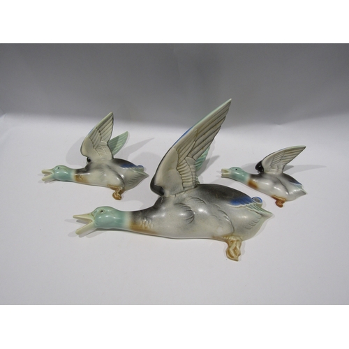 1411 - A set of three Beswick wall-mounted ducks, largest 30cm long, slight chip to larger wing