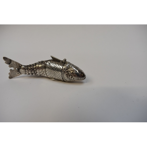 8023 - A white metal articulated fish pill pot, the sectioned ten piece body with hinged head opening to re... 