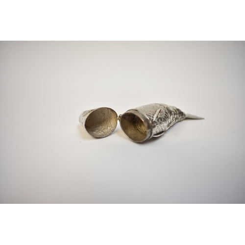 8023 - A white metal articulated fish pill pot, the sectioned ten piece body with hinged head opening to re... 