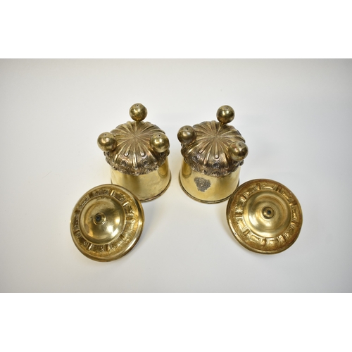 8082 - A pair of 17th/18th Century German silver gilt covered beakers, raised on three ball feet with Armor... 