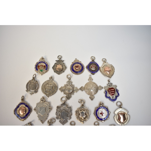 8107 - A box containing silver Alberts to include enamel and gold inlaid examples in Eastern brass casket (... 