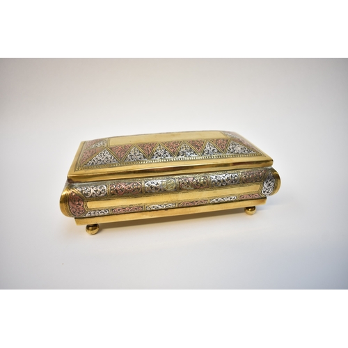 8107 - A box containing silver Alberts to include enamel and gold inlaid examples in Eastern brass casket (... 