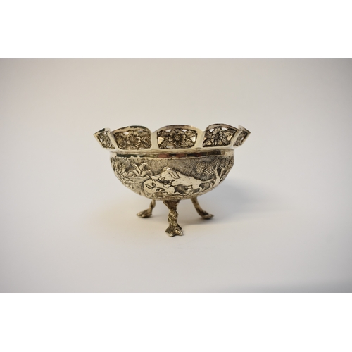 8052 - An Indian silver small bowl decoration with hunting lion, pierced border, raise on three feet, 7cm t... 