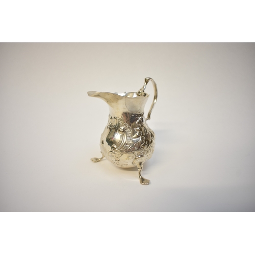 8055 - An Ann Smith & Nathaniel Appleton Georgian silver cream jug with floral detail raised on three feet,... 