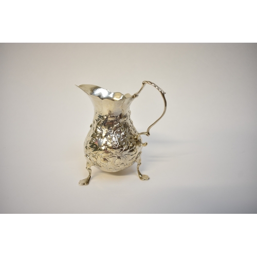 8055 - An Ann Smith & Nathaniel Appleton Georgian silver cream jug with floral detail raised on three feet,... 