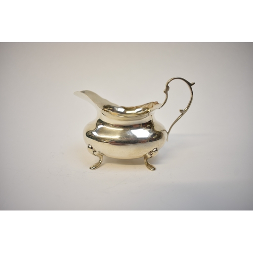 8059 - A Walker & Hall silver cream jug of plain form raised on four feet, Sheffield 1916, marks rubbed, 9.... 