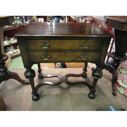 4010 - An 18th Century revival figured walnut lowboy of small proportions, the two drawers over bulbous tur... 