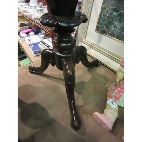 4012 - A Victorian burr walnut octagonal hinged top sewing table over a carved and turned column on a scrol... 