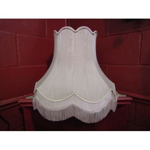 4138 - A brass standard lamp with pink fluted tasselled shade