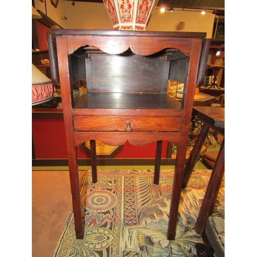 4209 - A George III mahogany two tier night stand the rising leaves over an open shelf and single drawer on... 