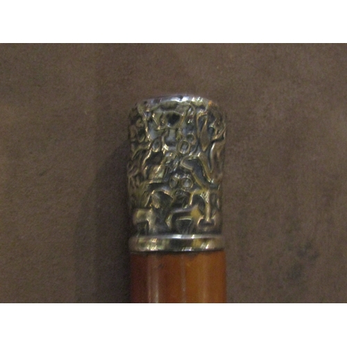 4211 - A malacca wood walking cane with white metal knop decorated with repoussé animals and foliage