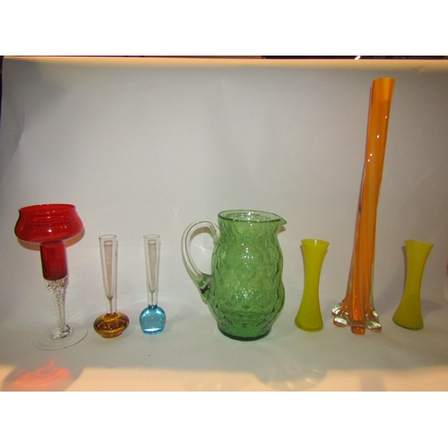 4228 - A group of retro mid Century glassware including a set of six Italian glasses, coloured glass vases ... 