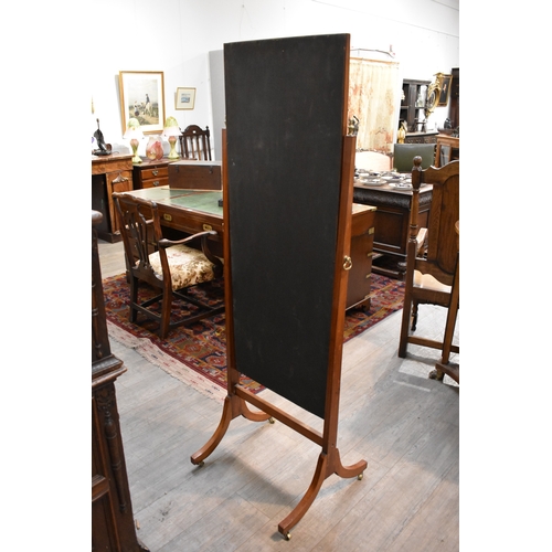 8485 - An early 20th Century mahogany full height Cheval mirror with outswept legs on brass castors, some d... 