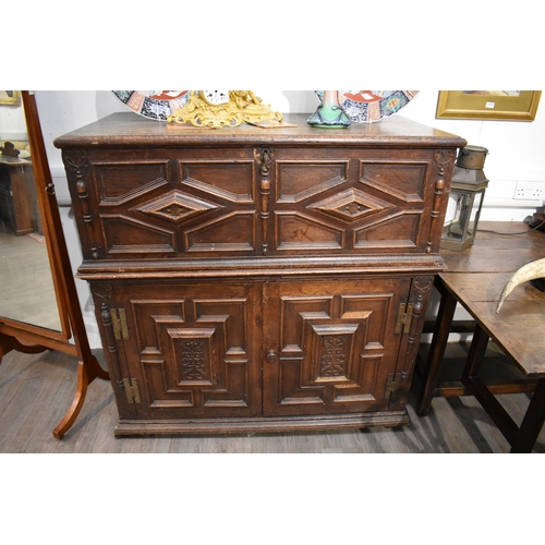 8488 - A late 17th/18th Century oak coffer on cupboard base with drawers to the interior, geometric moulded... 