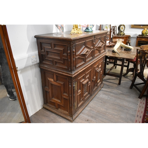 8488 - A late 17th/18th Century oak coffer on cupboard base with drawers to the interior, geometric moulded... 