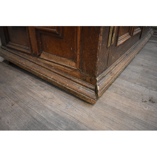 8488 - A late 17th/18th Century oak coffer on cupboard base with drawers to the interior, geometric moulded... 