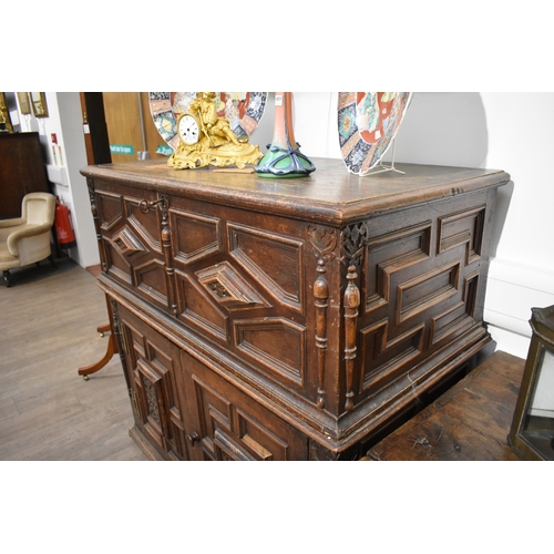 8488 - A late 17th/18th Century oak coffer on cupboard base with drawers to the interior, geometric moulded... 