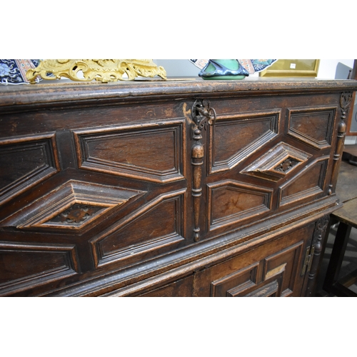 8488 - A late 17th/18th Century oak coffer on cupboard base with drawers to the interior, geometric moulded... 