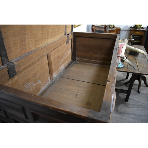 8488 - A late 17th/18th Century oak coffer on cupboard base with drawers to the interior, geometric moulded... 