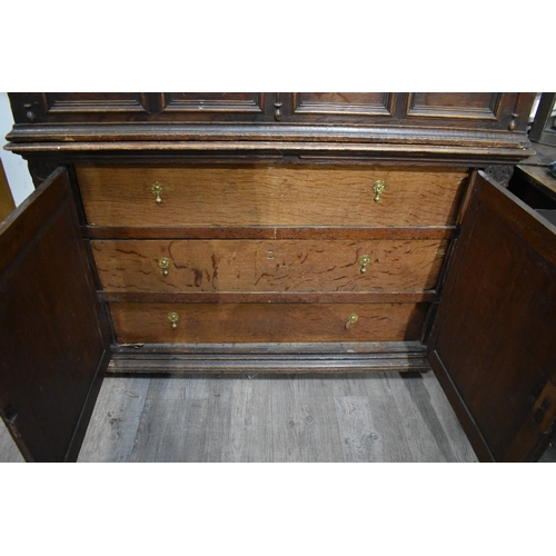 8488 - A late 17th/18th Century oak coffer on cupboard base with drawers to the interior, geometric moulded... 