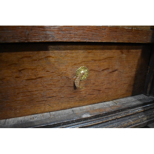 8488 - A late 17th/18th Century oak coffer on cupboard base with drawers to the interior, geometric moulded... 