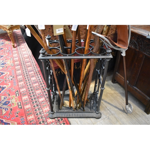 8614 - A cast iron stick stand with drip tray, 63cm x 43cm x 29cm (no sticks included)