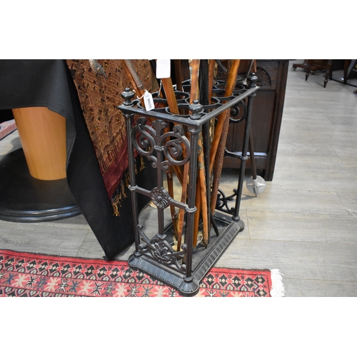 8614 - A cast iron stick stand with drip tray, 63cm x 43cm x 29cm (no sticks included)